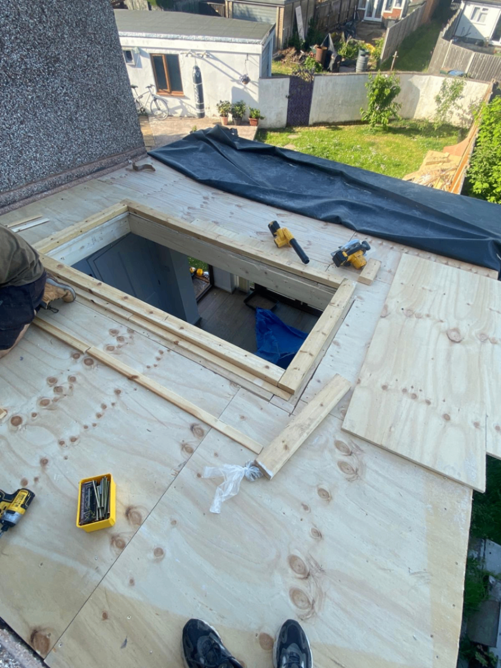 Close up of moss being removed by hand from roof tiles by The Roofing Lads