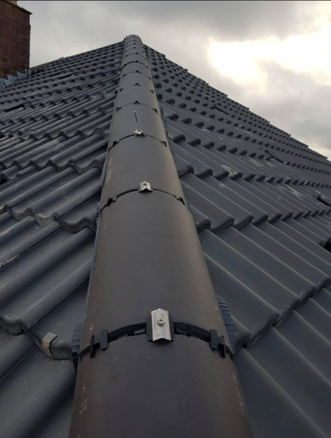 Close view of finished ridge tiles on a new roof