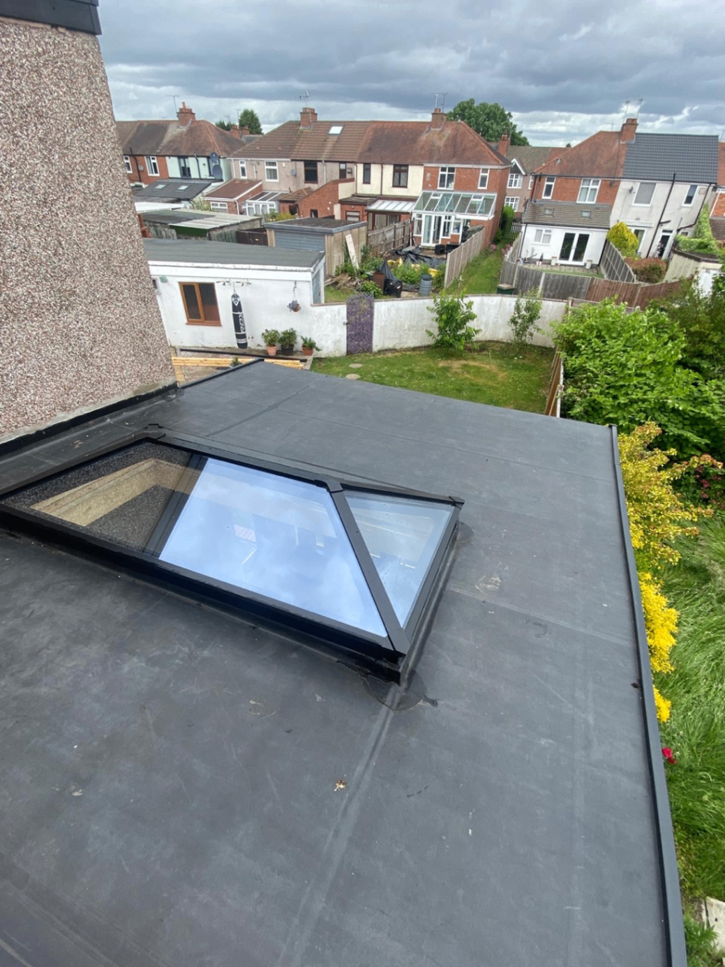 Completed flat roof with a glazed roof light